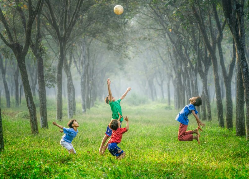 children jumping in forest